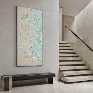 Tall mint coastal artwork displayed beside a modern stone staircase.