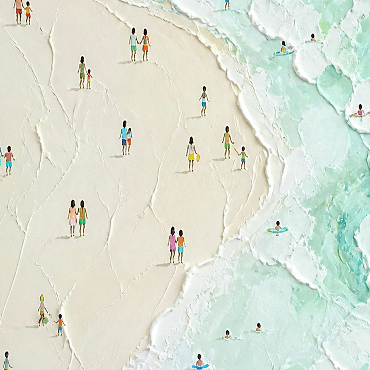 Close-up of raised ivory sand, mint surf, and tiny painted figures.