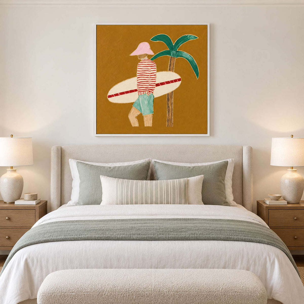 White-framed surfer artwork above a pale bed with muted green pillows and throw.