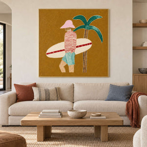 Ochre surfer painting above a cream sofa with rust, striped, and blue cushions.