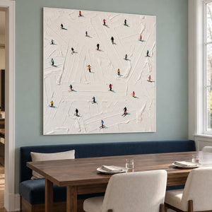 Skiers painting above a blue dining bench and wooden table.