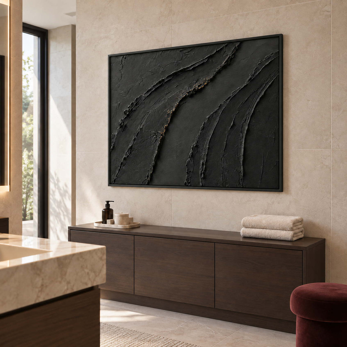 Sweeping raised black ridges with subtle gold accents in a black frame, displayed in a bathroom dry area.