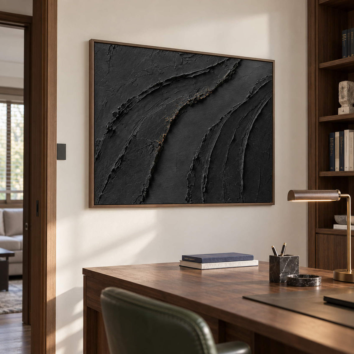 Sweeping raised black ridges with subtle gold accents in a brown wood frame, displayed in a home office.