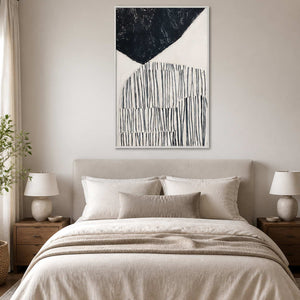 White framed abstract painting with dark curves and fine lines above a bed.