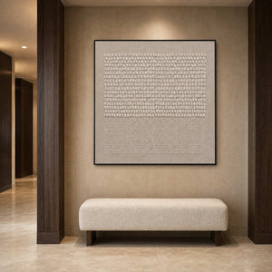 Square abstract relief artwork displayed in a boutique hotel corridor alcove.