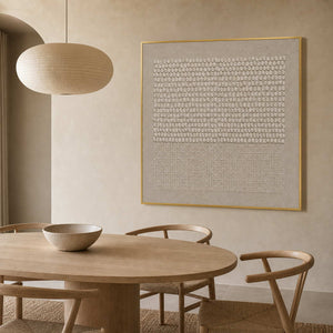Neutral sculptural wall art displayed in an organic modern dining room.
