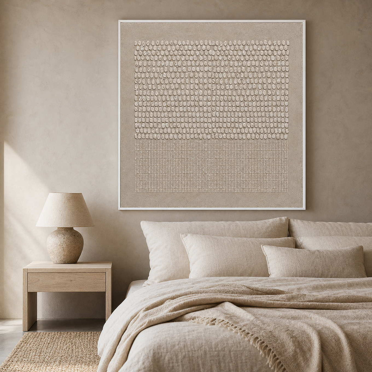 Textured ivory and taupe artwork displayed in a serene wabi-sabi bedroom.