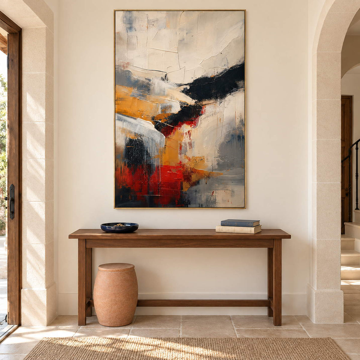 Ivory, ochre and red abstract strokes crossed by bold black bands in a gold frame, displayed in an entrance hall.