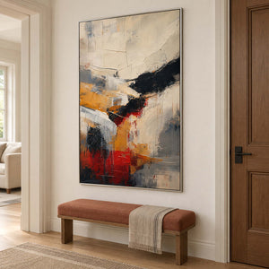 Ivory, ochre and red abstract strokes crossed by bold black bands in a silver frame, displayed in a hallway.