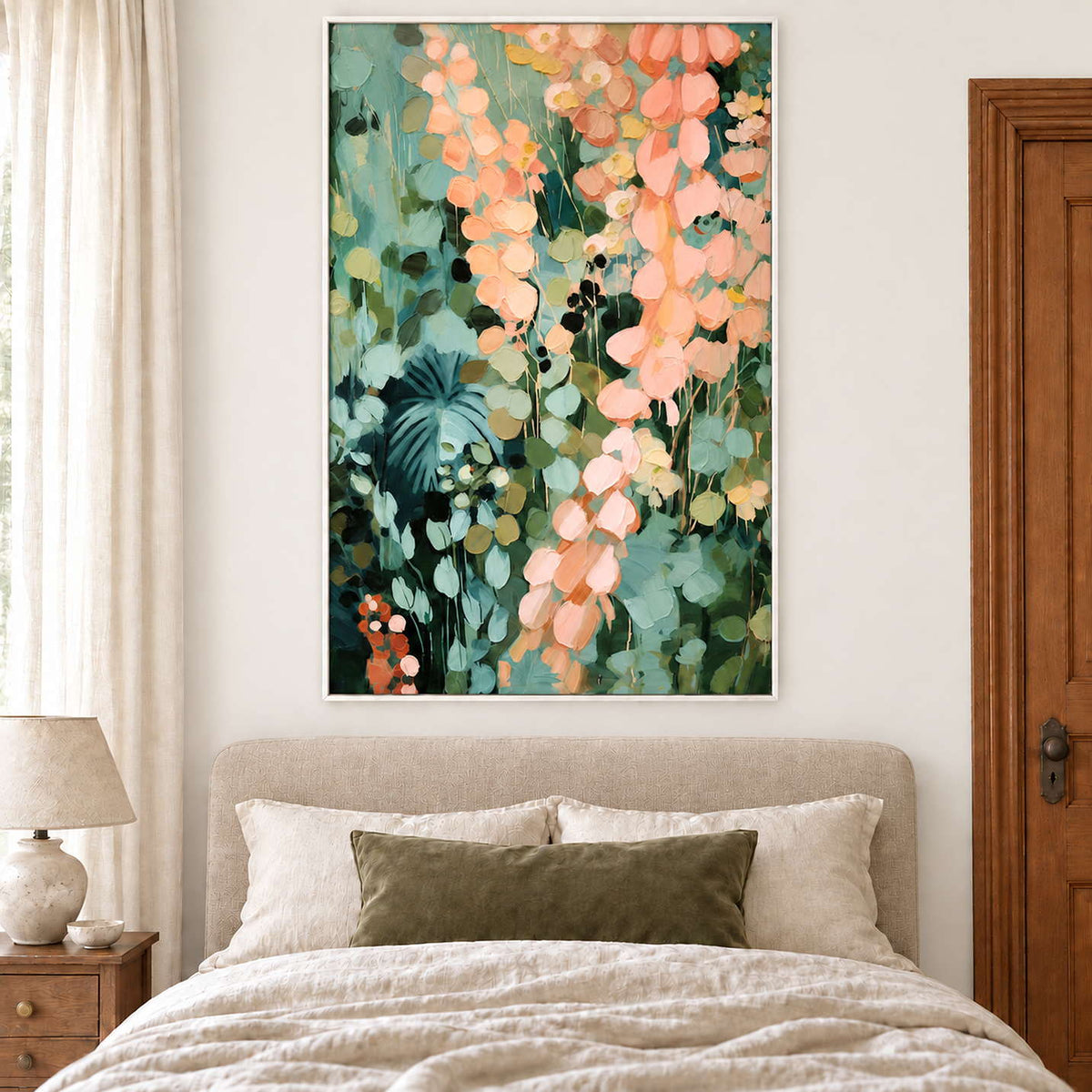 Cascading peach and blush leaves against deep green foliage in a white frame, displayed above a bed.