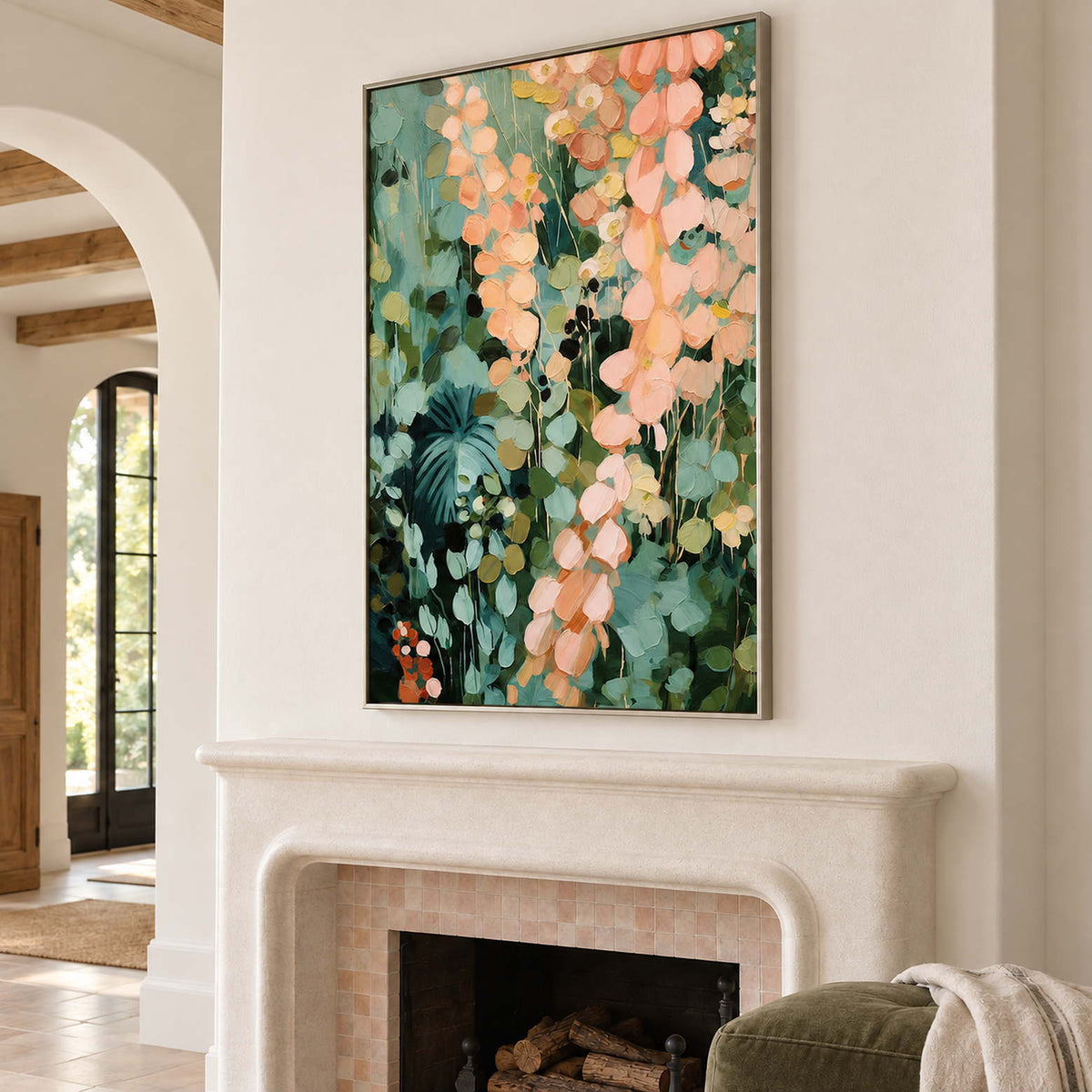 Cascading peach and blush leaves against deep green foliage in a silver frame, displayed above a fireplace.