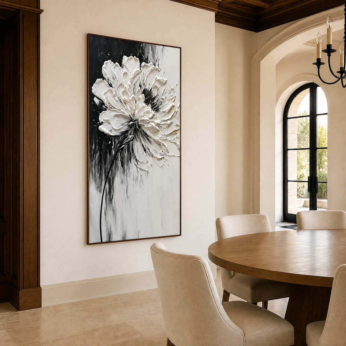 Wood framed white flower artwork beside a round table in a warm dining room.