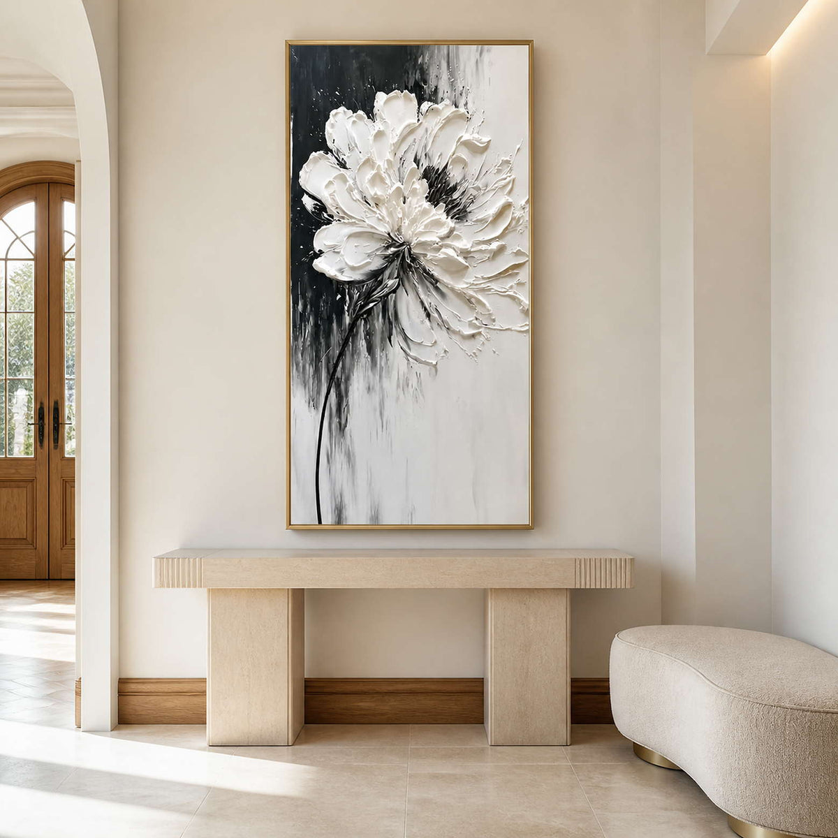 Gold framed tall flower artwork above a pale stone entryway console.