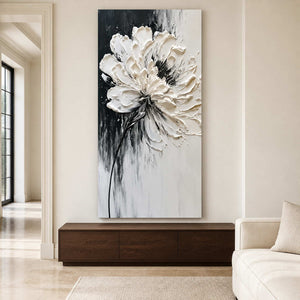 Frameless white floral artwork above a walnut cabinet beside a cream sofa.