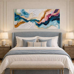 White-framed abstract above a blue-gray headboard with matching pale blue bedding.
