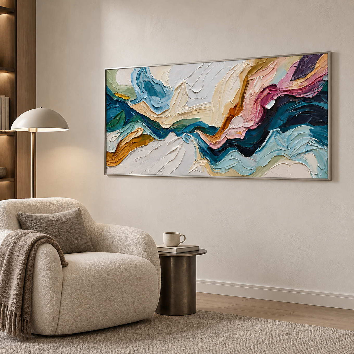 Wide color-sweep artwork beside a rounded cream chair and dome-shade reading lamp.