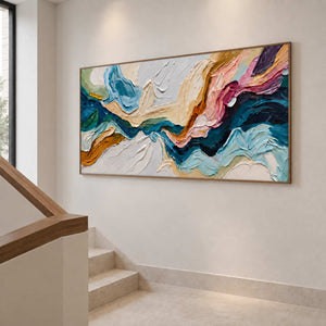 Angled view of blue, cream, and pink abstract artwork beside a pale staircase.
