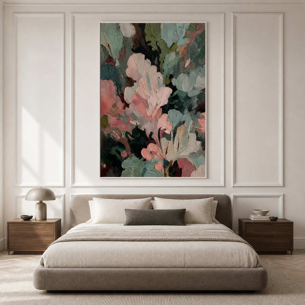 White framed pink and green abstract painting above a bed in a softly lit bedroom.
