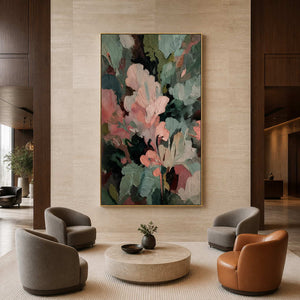 Gold framed textured abstract painting above curved chairs in a stone walled hotel lounge.