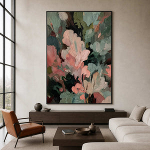 Black framed pink and green artwork above a console between lounge seating.