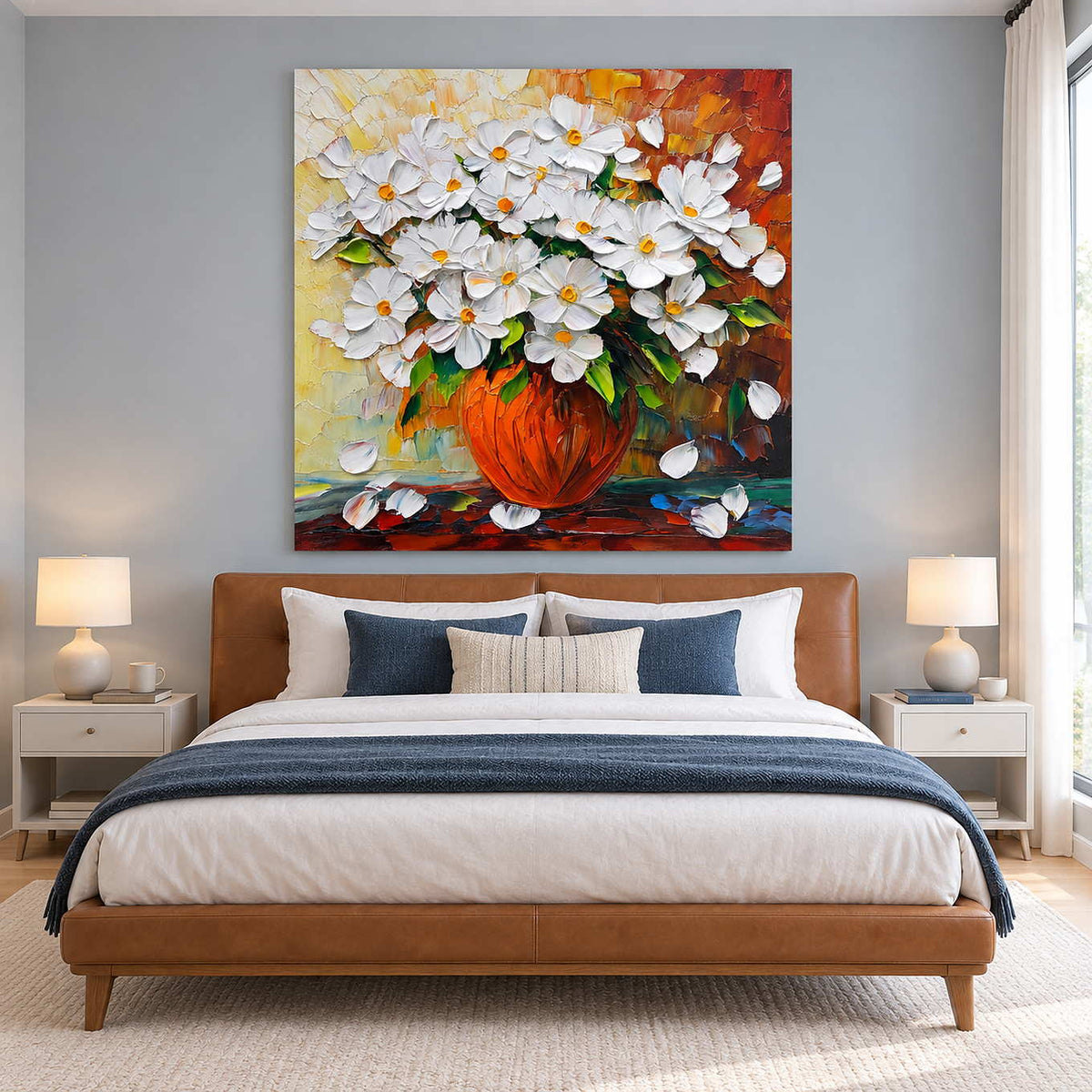 White bouquet painting above a tan bed with navy bedding.