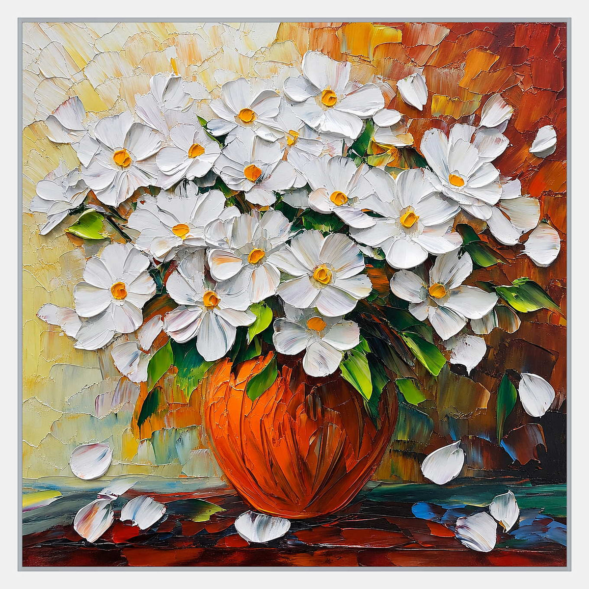 White flowers with yellow centers and green leaves in an orange-red vase, with loose petals on a colorful tabletop.