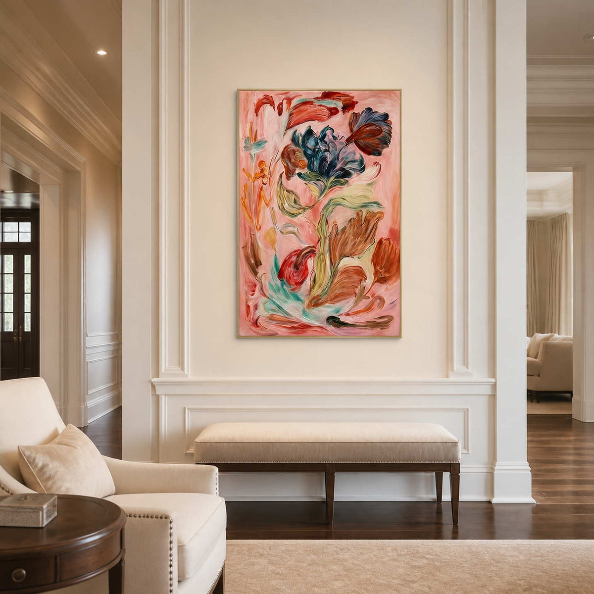 Gold framed pink floral artwork above an upholstered bench in a formal entrance hall.
