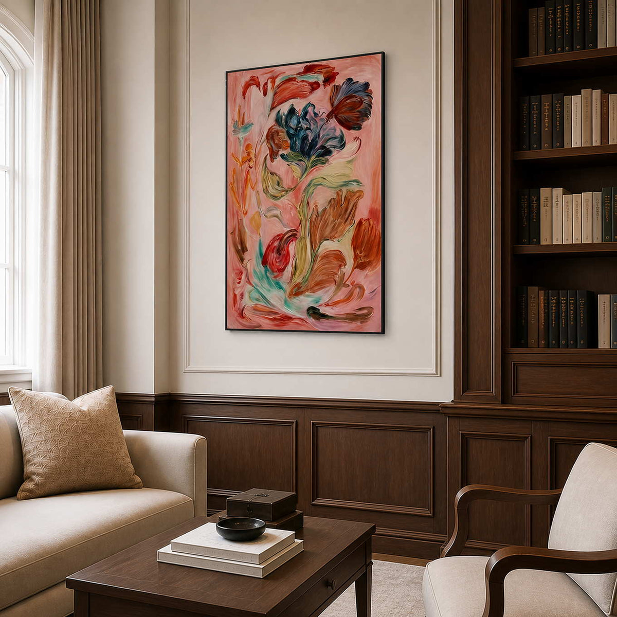 Black framed floral artwork beside dark wooden bookshelves and neutral seating in a study.