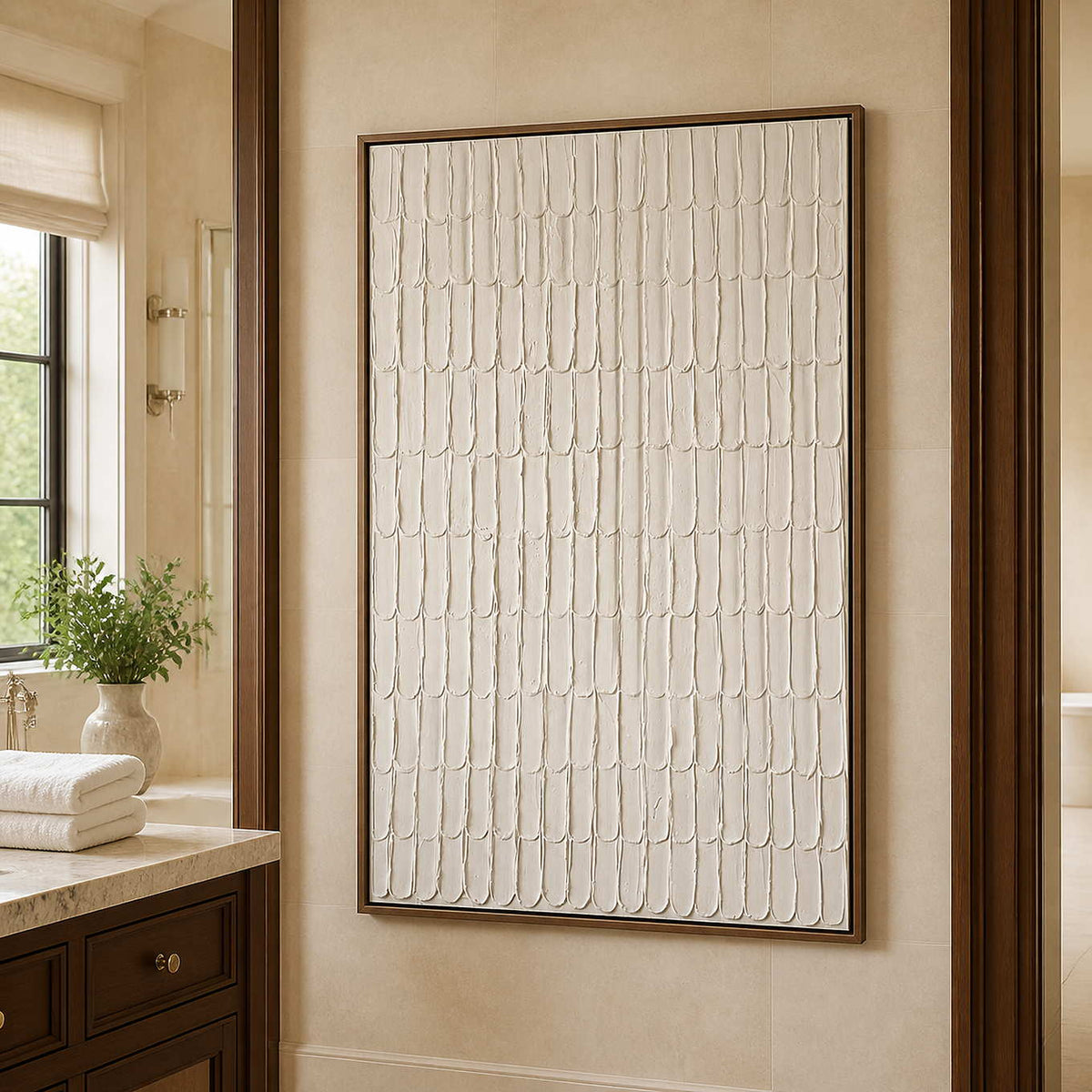 Wood framed cream textured artwork beside a stone vanity in a bathroom dry area.