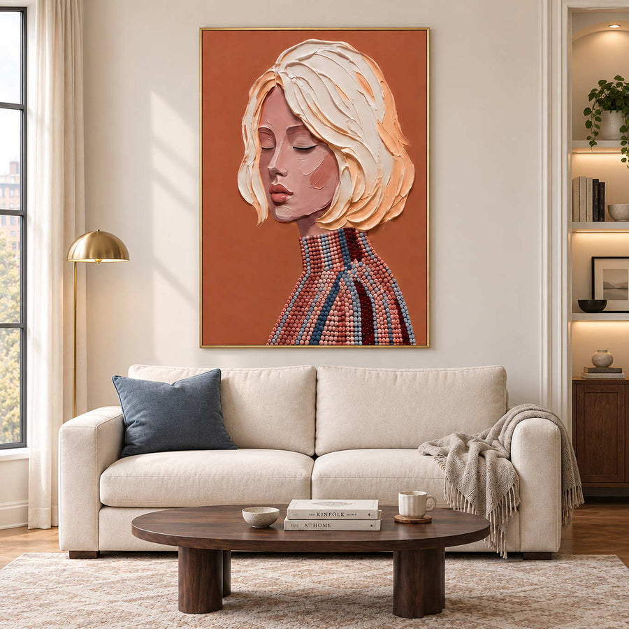A Gentle Thought in a gold frame above a cream sofa with a blue cushion and an oval wood coffee table.