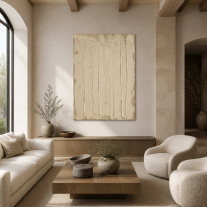Frameless cream textured artwork above wooden furniture in a warm living room.