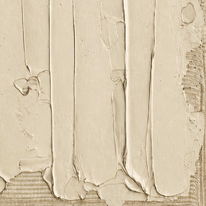 Close view of raised cream strokes, small surface pits and ridged edges.