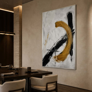 Black and gold textured wall art displayed in a designer dining room.