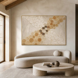Golden circles crossing an ivory field wall art in a contemporary living room.