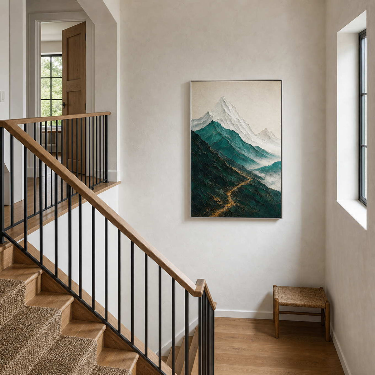 Textured mountain wall art displayed at a bright residential stair landing.