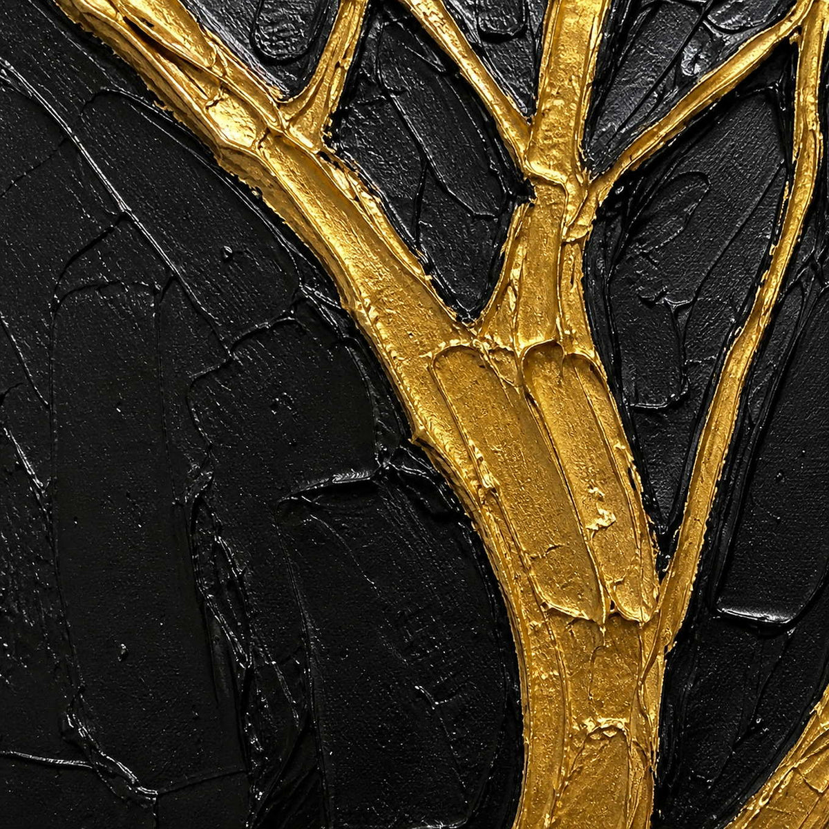 Close-up of raised gold tree texture against a hand-worked black surface.