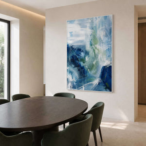 Cool blue abstract artwork above a contemporary round dining table.