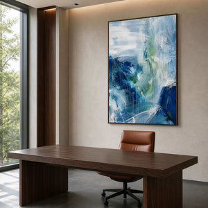 Atmospheric blue abstract wall art above a dark wood office desk.