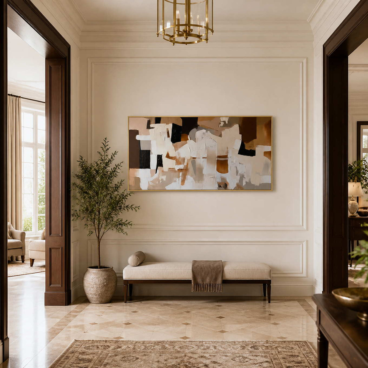 Gold framed cream and brown artwork above a bench in a bright hallway.