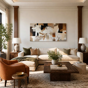 Frameless cream and brown abstract artwork above a sofa in a warm living room.