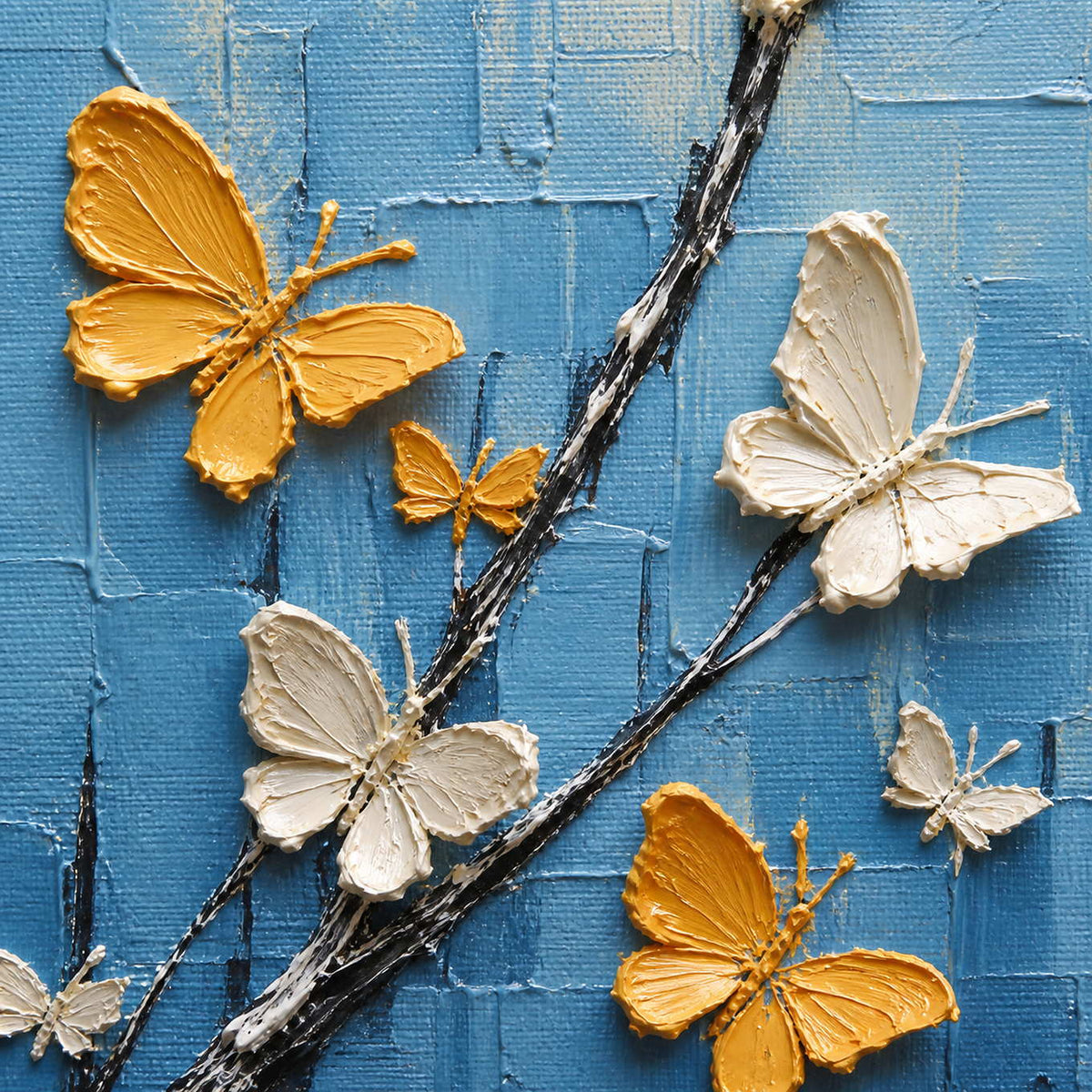 Close-up of raised gold ivory and red butterfly wings over blue texture.