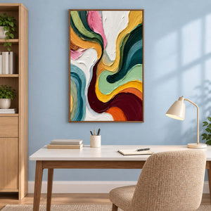 Textured color painting above a desk against a blue wall.