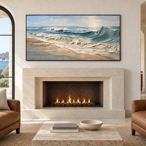 Coastal wave painting above a lit pale fireplace between brown armchairs.