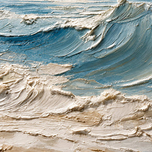 Detail of blue-gray wave ridges and cream foam flowing toward the textured sandy foreground.