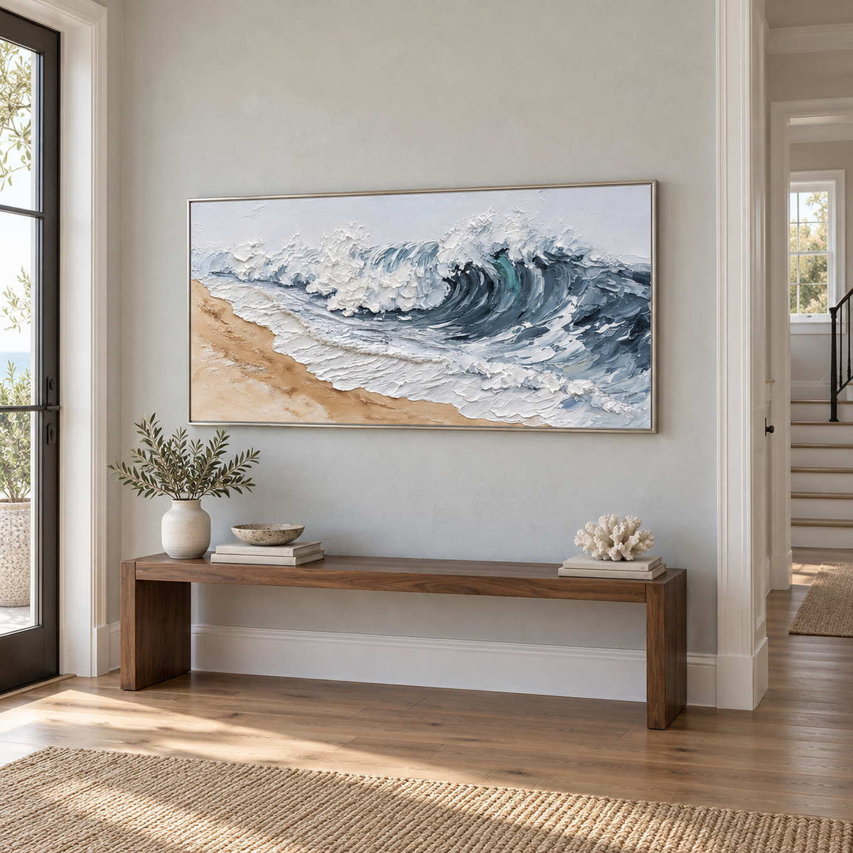 A Letter from the Waves in a silver frame above a narrow wood console in a bright hallway.