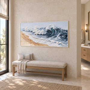 A Letter from the Waves in a white frame above a cushioned bench beside a vanity in a bathroom dry area.