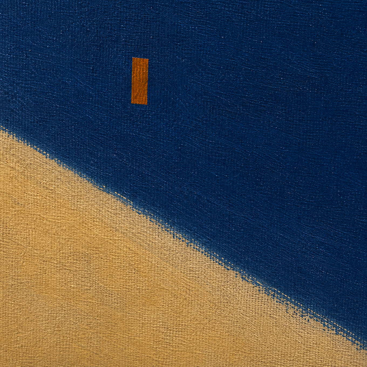 Close detail of cobalt blue and ochre painted canvas texture