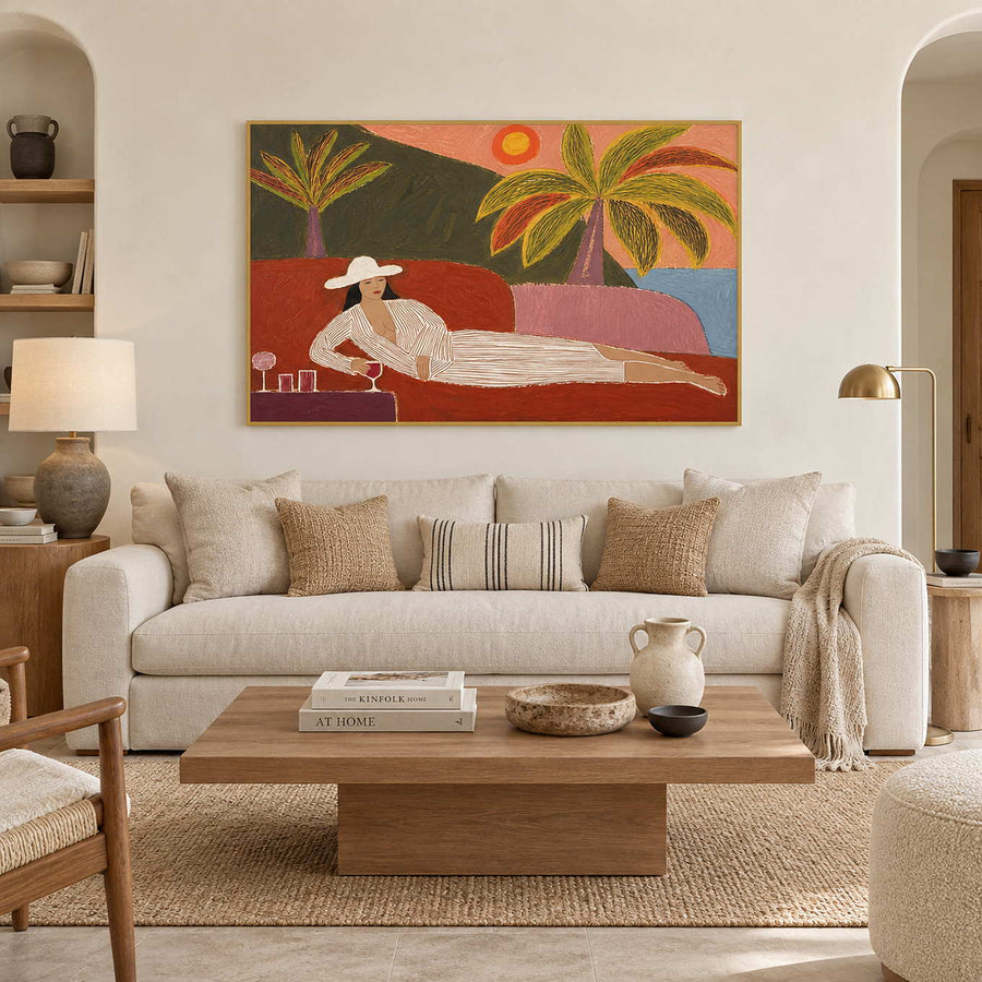 Reclining figure and palm artwork above a cream sofa and low wood coffee table.