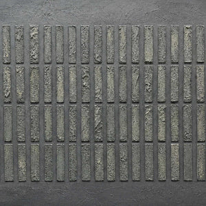 Close-up of raised hand-painted texture in black, neutral, and earth tones.
