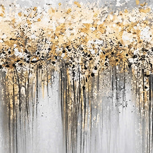 Close view of golden and white flecks with dark trails on a gray painted surface.